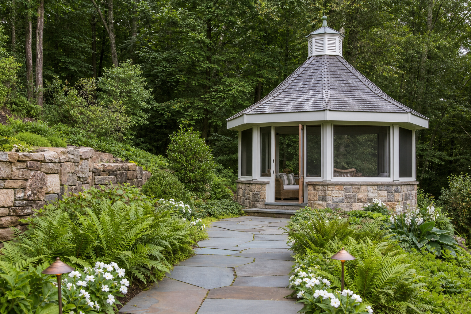 Shingle-style hexagonal garden gazebo with cedar roof, fieldstone and wood half-walls, screened openings, and bluestone garden path in Norwalk