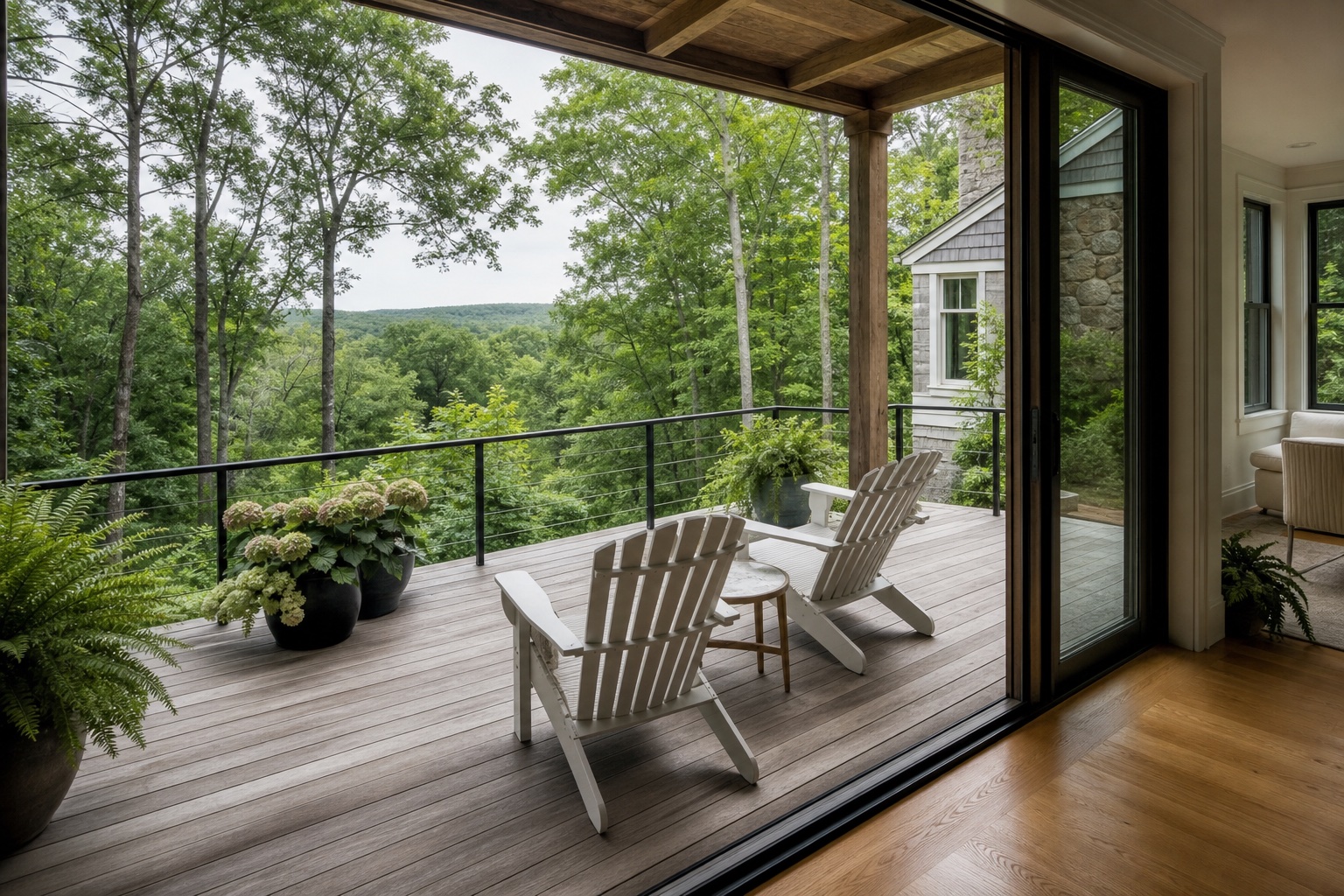 Home with cedar deck, Adirondack seating, and wooded hillside view through sliding glass doors in Weston